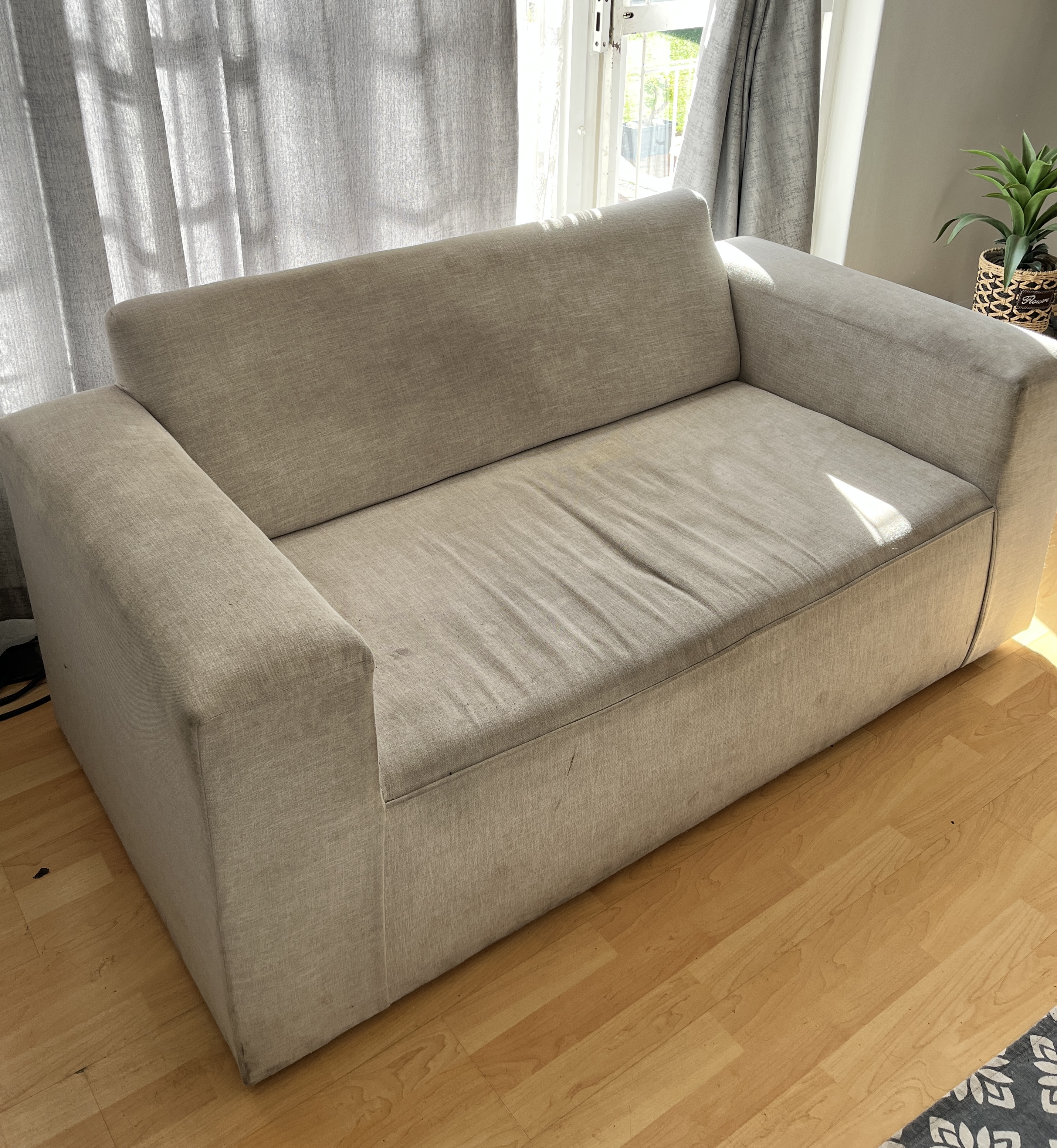 Two-seater fabric couch before cleaning
